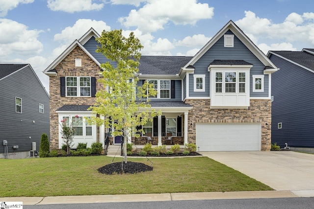 craftsman house with a garage, a front yard, and covered porch