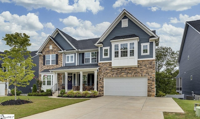 craftsman house with a garage, covered porch, and a front lawn