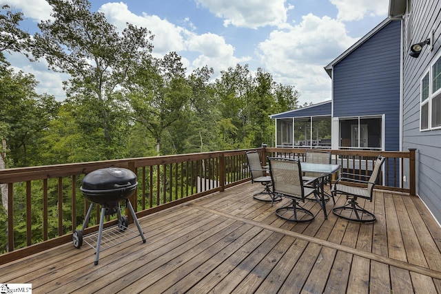 deck featuring a sunroom and grilling area