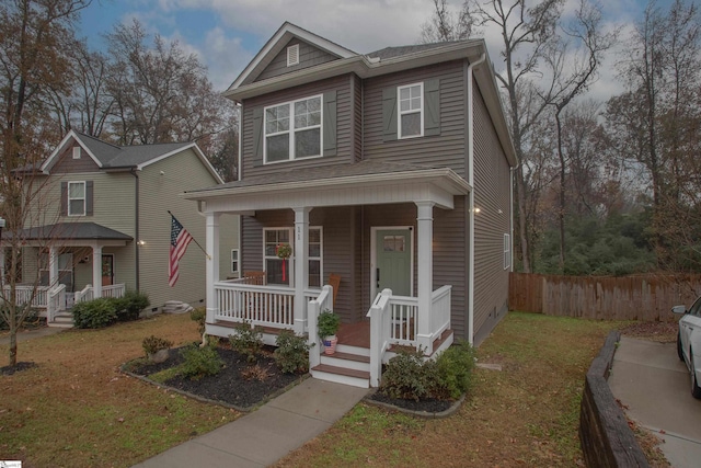 view of front of property featuring a front yard and covered porch