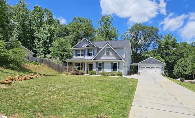 craftsman inspired home featuring a garage, an outbuilding, a front yard, and covered porch