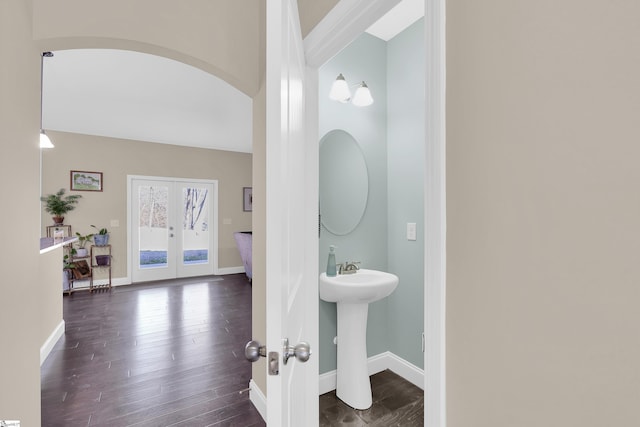 bathroom with hardwood / wood-style flooring, sink, and french doors