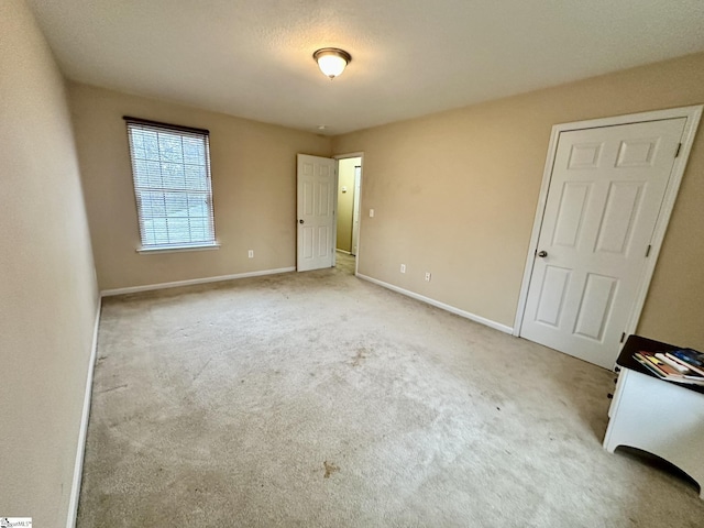 unfurnished bedroom featuring light carpet