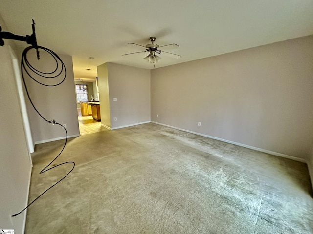 unfurnished living room with light colored carpet and ceiling fan