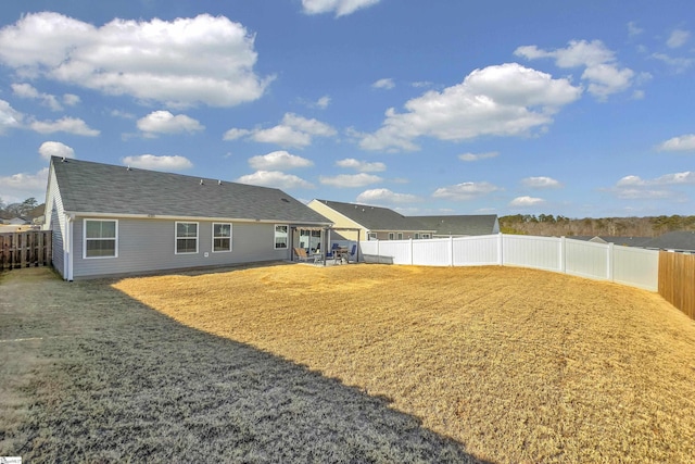 rear view of house featuring a yard