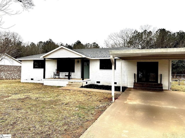 ranch-style house featuring brick siding, a porch, a shingled roof, crawl space, and a front lawn