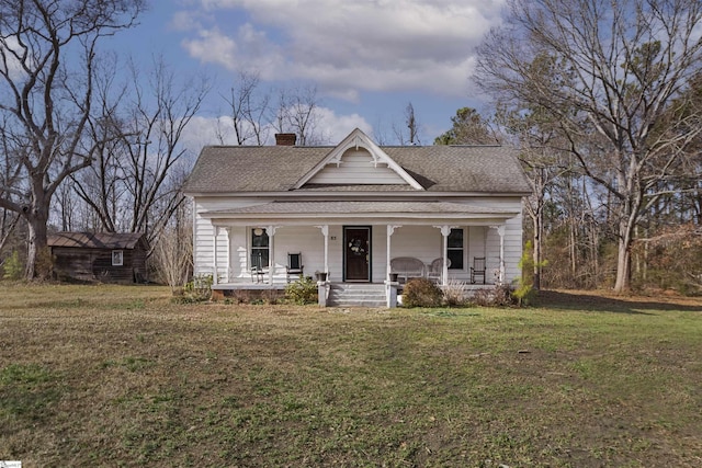 view of front of home with a porch and a front yard