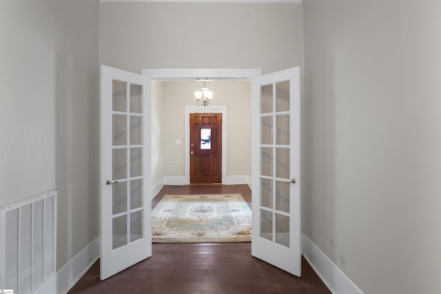 entrance foyer featuring dark hardwood / wood-style flooring and french doors