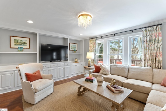 living room featuring hardwood / wood-style floors, crown molding, and a chandelier