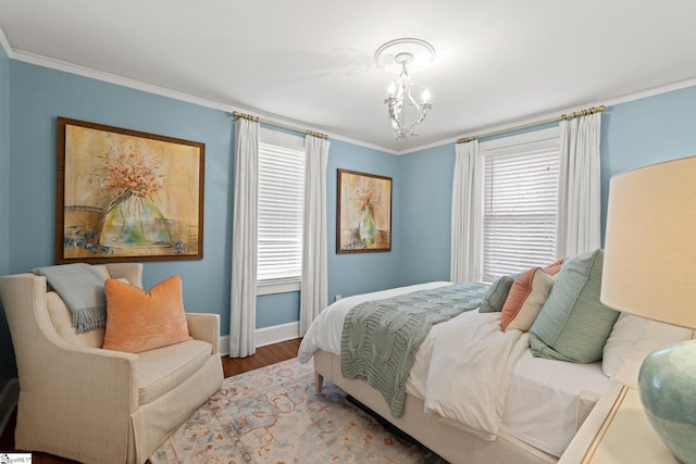 bedroom featuring ornamental molding, hardwood / wood-style floors, and a chandelier