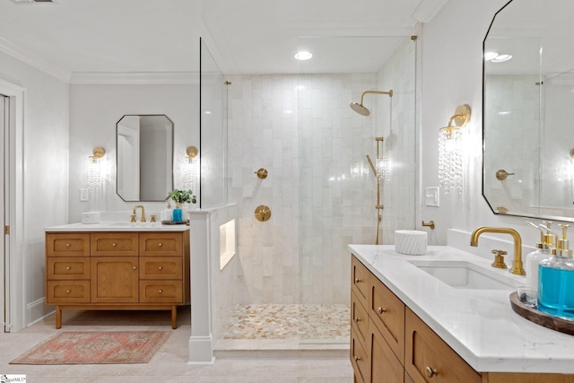 bathroom with vanity, crown molding, and tiled shower