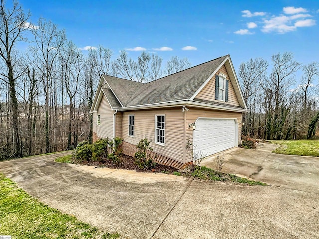 view of side of home with a garage