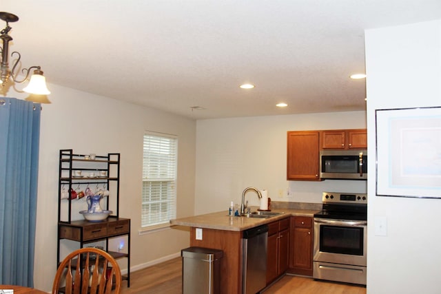 14 Heatherfield Dr, Simpsonville, SC 29680 - kitchen featuring light wood-type flooring, recessed lighting, a peninsula, appliances with stainless steel finishes, and a sink