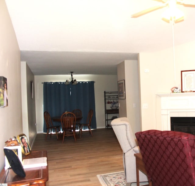 14 Heatherfield Dr, Simpsonville, SC 29680 - dining area with a fireplace, ceiling fan with notable chandelier, baseboards, and wood finished floors