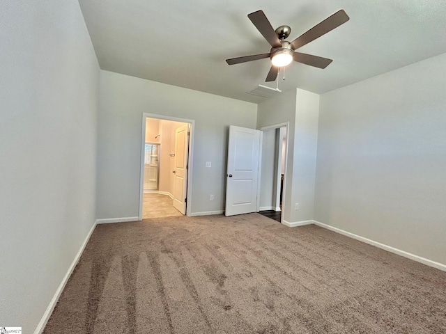 unfurnished bedroom with light colored carpet, ceiling fan, and ensuite bathroom