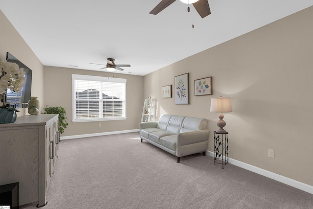 living room featuring light carpet and ceiling fan