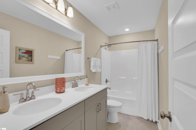 full bathroom featuring vanity, shower / tub combo, tile patterned floors, and toilet