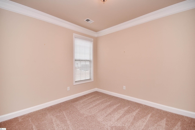 carpeted spare room featuring crown molding