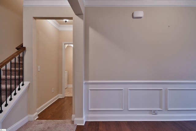 staircase featuring hardwood / wood-style floors and crown molding