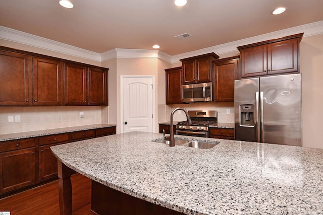 kitchen featuring stainless steel appliances, sink, light stone counters, and dark hardwood / wood-style floors