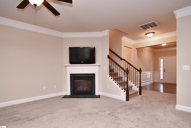 unfurnished living room featuring ornamental molding, carpet, and ceiling fan