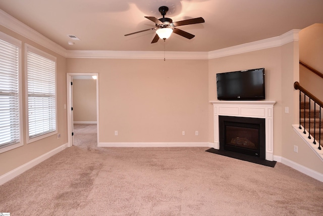 unfurnished living room with ornamental molding, light colored carpet, and ceiling fan