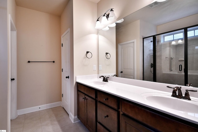 bathroom featuring vanity, tile patterned flooring, and walk in shower