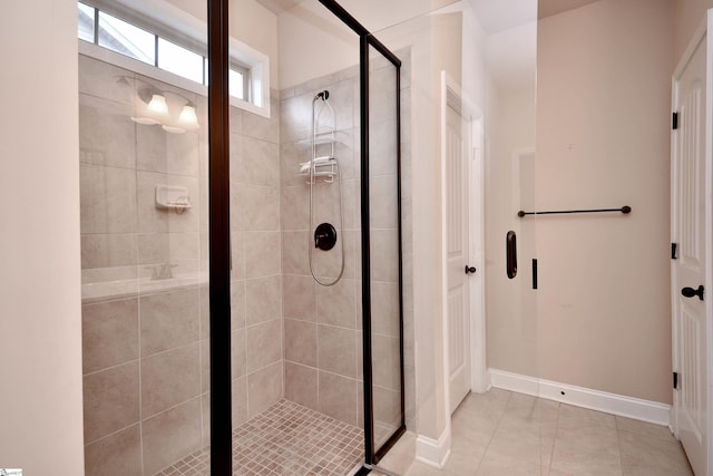 bathroom featuring an enclosed shower and tile patterned floors