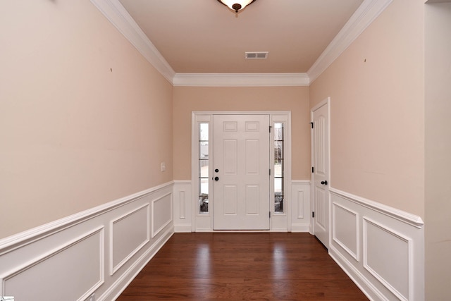 entryway with ornamental molding and dark hardwood / wood-style flooring