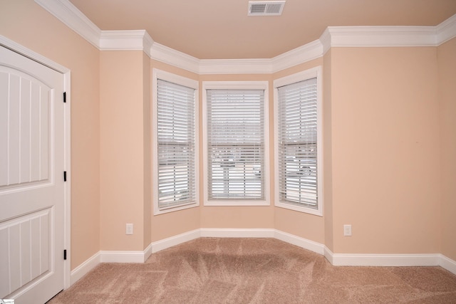 carpeted empty room featuring ornamental molding