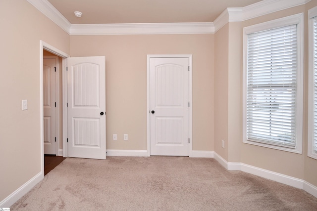 unfurnished bedroom featuring ornamental molding and light carpet