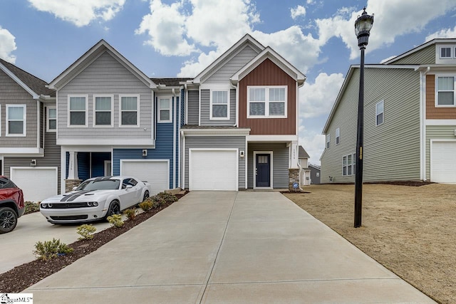 view of property featuring a garage and a front lawn