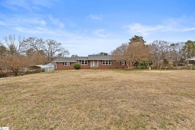 view of front of house featuring a front yard and a carport