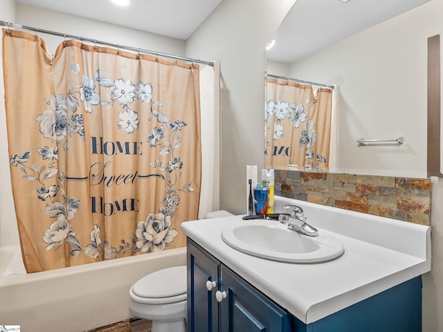 full bathroom featuring shower / bath combination with curtain, vanity, and toilet