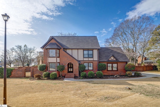 english style home featuring a front lawn