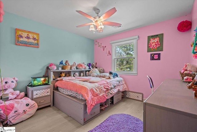 bedroom with ceiling fan and light hardwood / wood-style floors