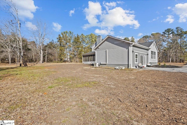 view of side of home featuring a sunroom