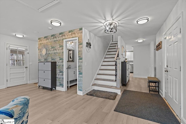 entrance foyer with sink and light hardwood / wood-style flooring