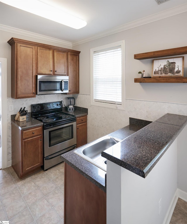 kitchen featuring sink, ornamental molding, light tile patterned floors, kitchen peninsula, and stainless steel appliances