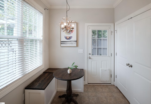 doorway to outside featuring crown molding, a notable chandelier, and tile patterned floors