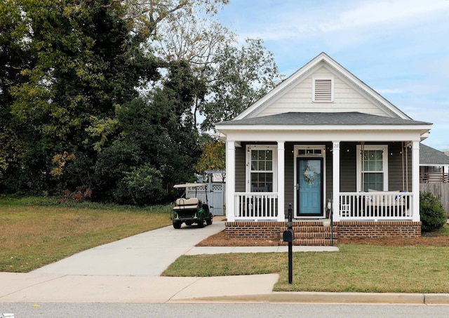 view of front of house featuring a front yard and covered porch