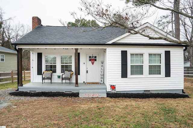 view of front of house featuring a front yard and covered porch