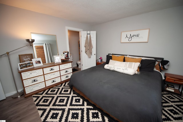 bedroom with hardwood / wood-style floors and a textured ceiling