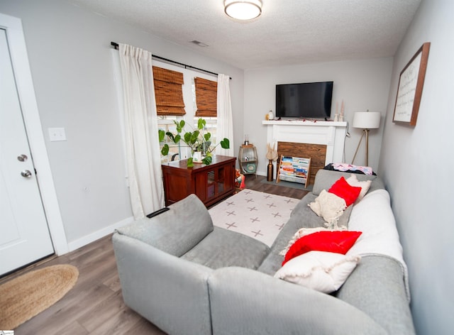 living room with hardwood / wood-style floors and a textured ceiling