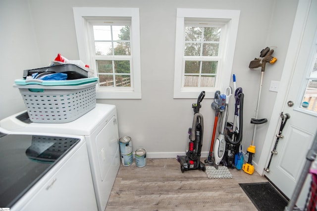 washroom featuring washing machine and dryer and light hardwood / wood-style floors