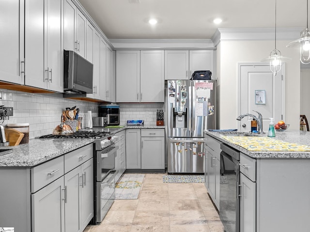 kitchen featuring sink, gray cabinets, appliances with stainless steel finishes, backsplash, and ornamental molding