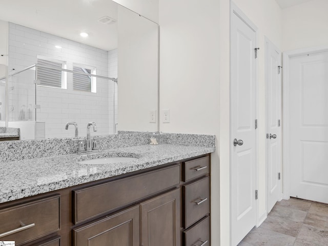 bathroom featuring an enclosed shower and vanity