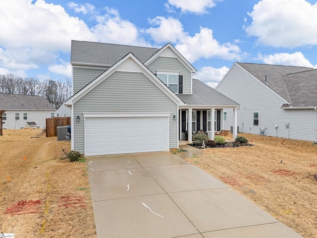 view of front of property featuring a garage, covered porch, and a front lawn