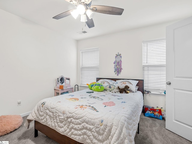 bedroom with multiple windows, carpet, and ceiling fan