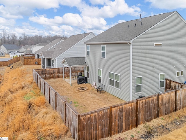 back of property featuring a patio and an outdoor fire pit